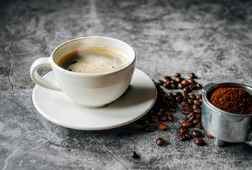 Aromatic Coffee cup and beans with ground coffee on Portafilter, Espresso coffee cup aromatic and making equipment