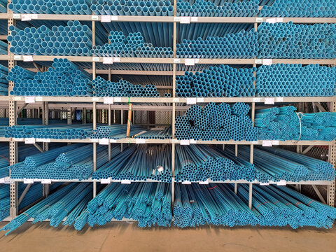 Pvc pipes background.Stacked plastic pipes in a warehouse. Pvc pipes for construction.