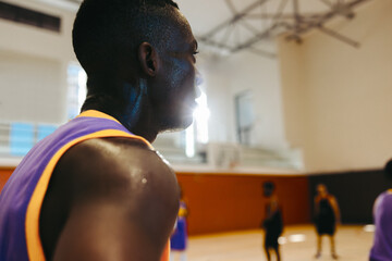 Basketball player focused during a game in an indoor court