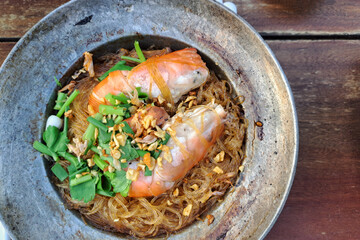 Gourmet Prawn Dish with Glass Noodles Served in a Rustic Pan