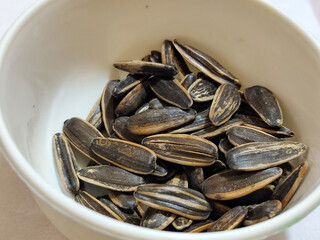 Roasted sunflower seeds in black and white striped shells, ready to be enjoyed as a healthy snack.