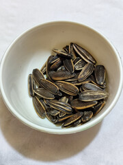 Roasted sunflower seeds in black and white striped shells, ready to be enjoyed as a healthy snack.