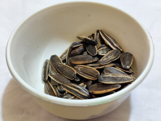 Roasted sunflower seeds in black and white striped shells, ready to be enjoyed as a healthy snack.