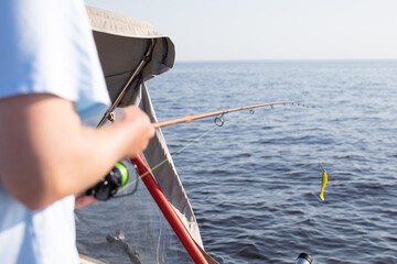 fisherman fishing, Fishing rod, spinning, fisherman against blue sky