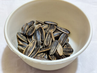 Roasted sunflower seeds in black and white striped shells, ready to be enjoyed as a healthy snack.