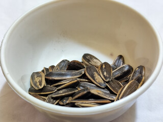 Roasted sunflower seeds in black and white striped shells, ready to be enjoyed as a healthy snack.