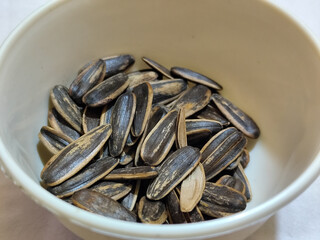 Roasted sunflower seeds in black and white striped shells, ready to be enjoyed as a healthy snack.