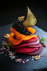 Elegant fusion of beetroot and carrots with caviar, gold leaf and truffle oil on slate plate Generative AI