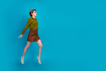 Young stylish woman in trendy fashion on blue background showcasing modern elegance and casual charm