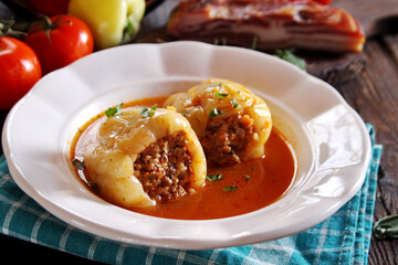 Stuffed peppers with minced meat and rice in tomato sauce
