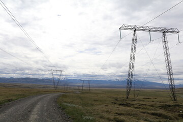 high voltage power lines transporting electricity over the empty barren icelandic highlands
