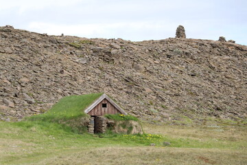 modern but traditional turf house with grass roof blending into the rugged icelandic landscape