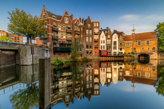 Rotterdam, Netherlands - 16 July 2025: View of the canal reflecting vibrant, historic buildings under a serene blue sky, capturing the essence of Dutch charm.
