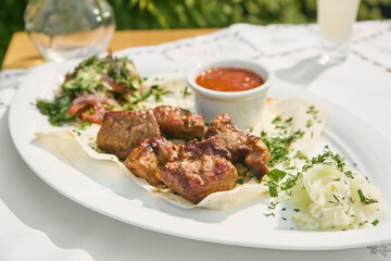 Pork shashlik on lavash, bright outdoor lighting, overhead summer composition