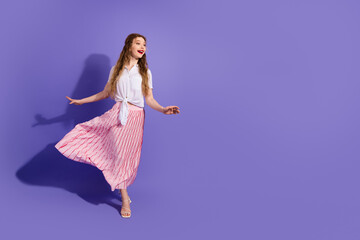 Young woman in stylish outfit posing against a vibrant purple background exuding charm fashion and confidence