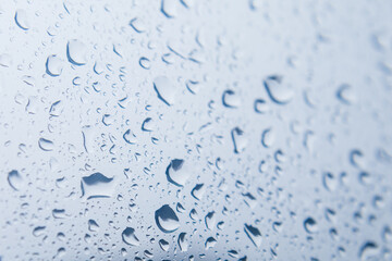Close up of raindrops falling on glass windows

