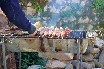 Grilling delicious souvlaki skewers outdoors