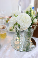Beautiful bouquet of white flowers in a vase. Festive decor.