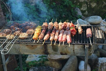 Delicious greek souvlaki and meats grilling outdoors