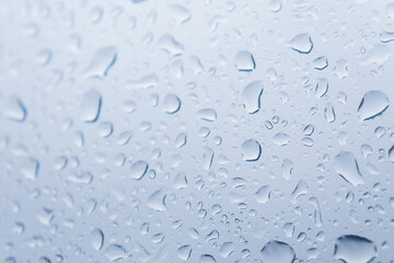 Close up of raindrops falling on glass windows
