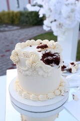 A beautiful holiday cake is bitten off. Holiday cake