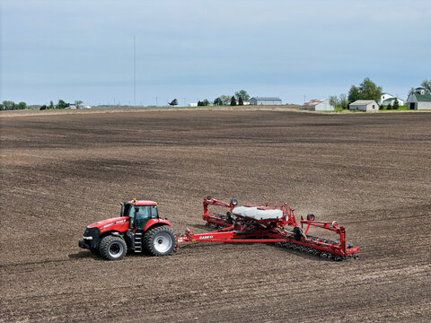 Oglesby, Illinois - USA -  April 29, 2025 Case IH 290 Magnum tractor pulling a Case IH 1250 Vacuum Hydraulic Drive 24 row planter
