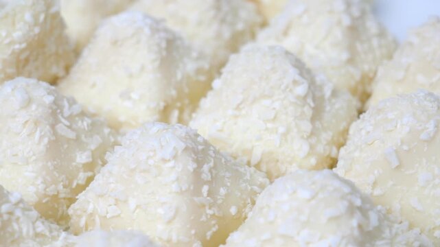 Candy wrapped in coconut chips. A delicious dessert of crispy waffles, sweet, delicate cream sprinkled with coconut chips