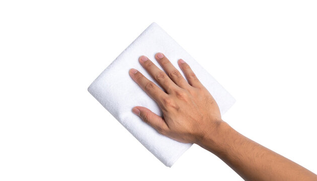 A hand is wiping a white surface with a folded white cloth against a black background. - Powered by Adobe