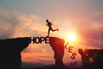 Silhouette of a man running on word HOPE pass to cliff with word LESS falling down. Concept of determination, creating opportunities to change situations and creating motivation to move forward.