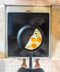 Steel skillet holding three bright eggs representing dawn is promise resilience and the start of a journey