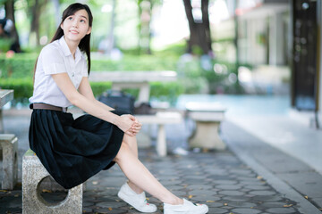 In the university's official calendar, an Asian female student wears a uniform as the August model, symbolizing excellence, elegance, and student empowerment throughout the year.