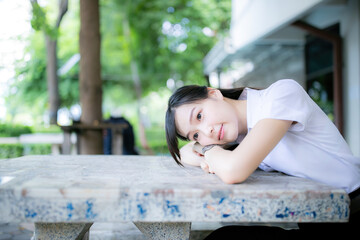 A beautiful and cute female student from the law faculty posed near the university library for a portrait photo shoot, radiating both confidence and academic determination through her gaze.