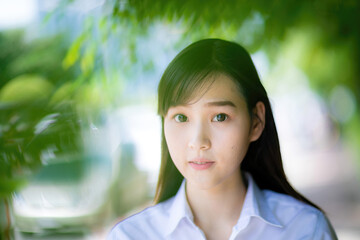 At the university’s photo day, a cute college student with an Asian look enjoyed posing for...