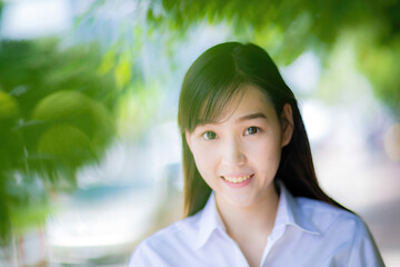 A cute college student with an Asian look walked gracefully across the university courtyard, later...