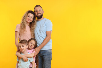 Happy family on yellow background. Space for text