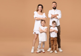 Happy family posing on beige background. Space for text