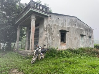 Motorbike in front of Concrete house in Vietnam village