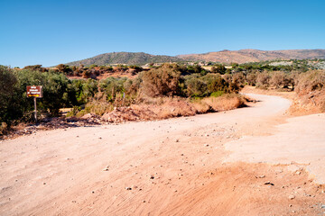Gravel road through arid landscape to Lara Beach, Paphos, Cyprus.