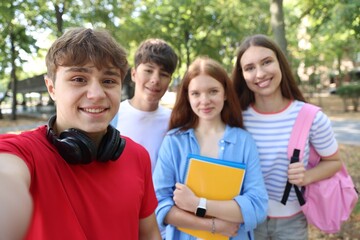 Group of teenagers taking selfie in park