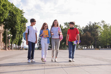 Group of teenagers walking together on city street