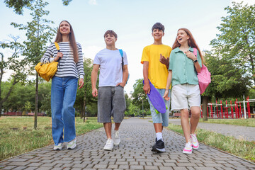 Group of teenagers spending time together outdoors, low angle view
