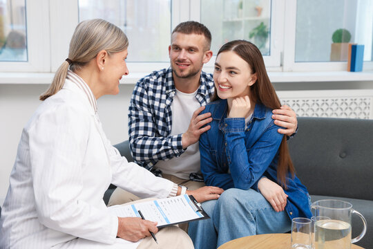 In vitro fertilization (IVF). Doctor encouraging young couple in reproductive clinic
