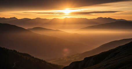 Majestic sunset over a hazy mountain range, golden light illuminating distant peaks.