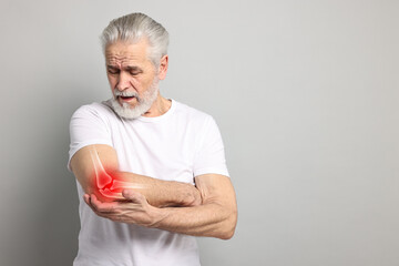 Arthritis. Senior man suffering from pain in elbow on grey background, space for text. Illustration...