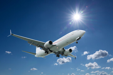 Airplane flying in beautiful blue sky with clouds