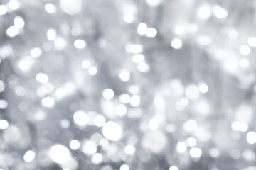Blurred shiny silver background with sparkling glitter, bokeh effect
