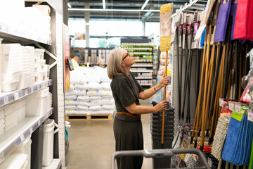 Moment of decision for a modern woman shopping for home essentials in a retail store