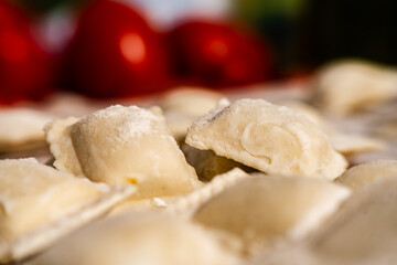 Fresh homemade uncooked ravioli pasta sprinkled with flour