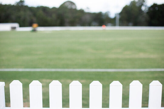 white picket fence around a local cricket field