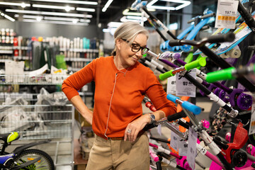 Woman choosing and purchasing items in a hypermarket highlighting real emotions and interactions...
